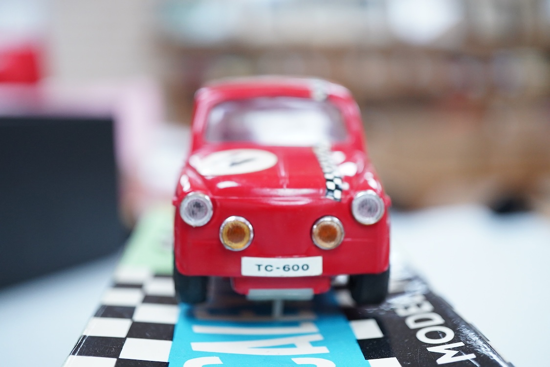 A boxed Tri-ang Scalextric T. C. Seat 600 (C-31) in red, with correct red spot box, together with an unboxed Hurricane combination motorcycle and sidecar MM/82